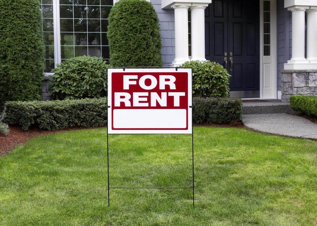 Closeup view of suburban home with For Rent sign.