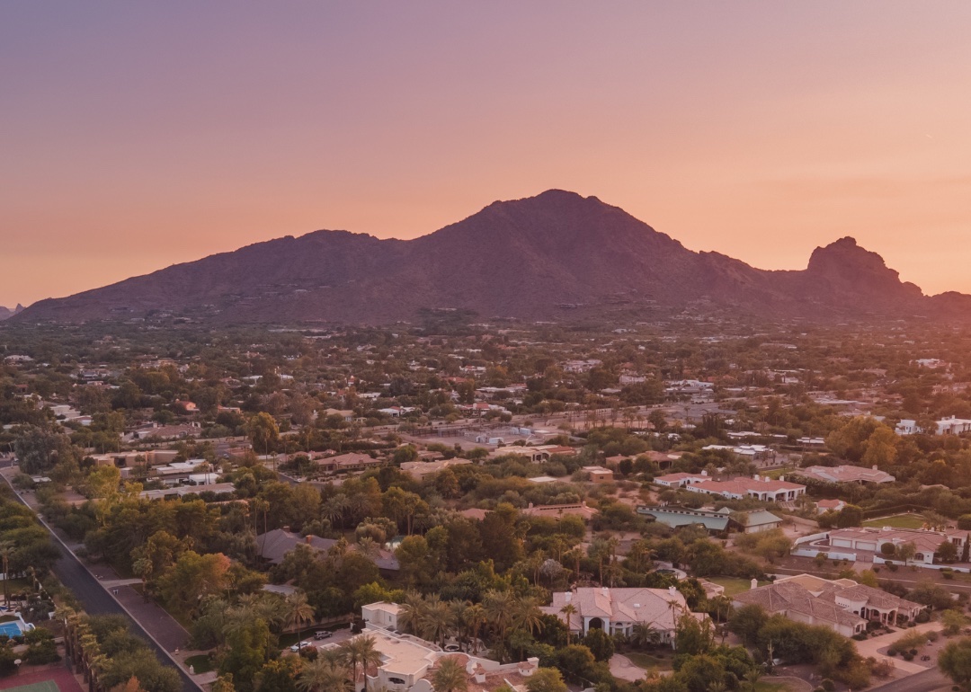 Homes in Scottsdale and a mountain in the background at sunset.